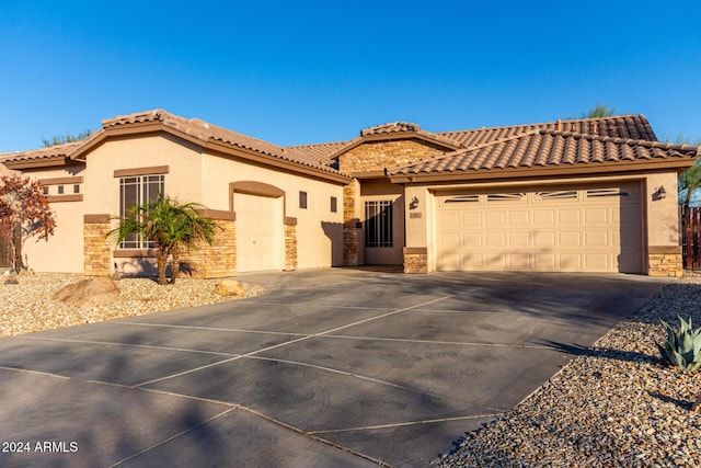 mediterranean / spanish-style house with a garage