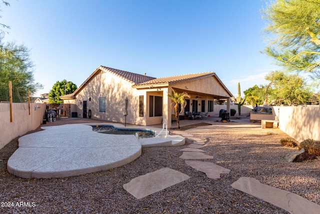 back of house with a fenced in pool, ceiling fan, and a patio