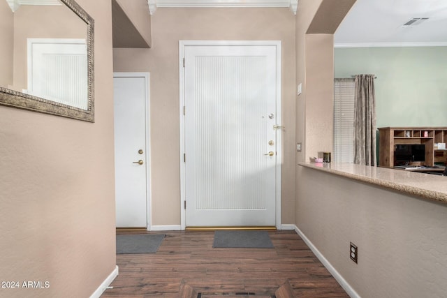 doorway to outside with dark hardwood / wood-style floors and ornamental molding