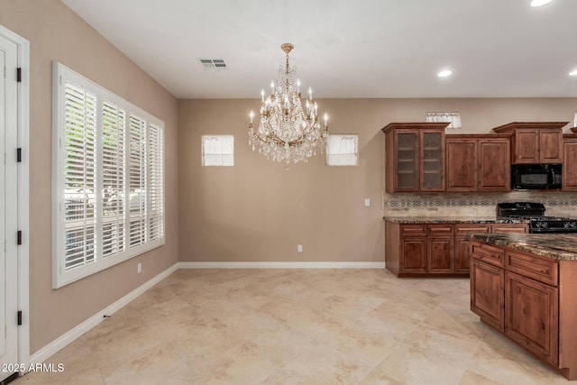 1260 E Sweet Citrus Dr, Queen Creek, AZ 85140 - kitchen featuring black appliances, a chandelier, tasteful backsplash, glass insert cabinets, and recessed lighting