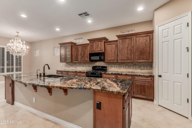 1260 E Sweet Citrus Dr, Queen Creek, AZ 85140 - kitchen with black appliances, a sink, a breakfast bar, decorative backsplash, and a large island with sink