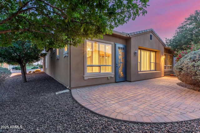 1260 E Sweet Citrus Dr, Queen Creek, AZ 85140 - back of property at dusk featuring a patio area and stucco siding