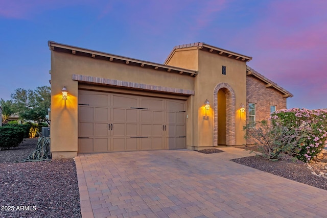1260 E Sweet Citrus Dr, Queen Creek, AZ 85140 - mediterranean / spanish house featuring a garage, decorative driveway, and stucco siding