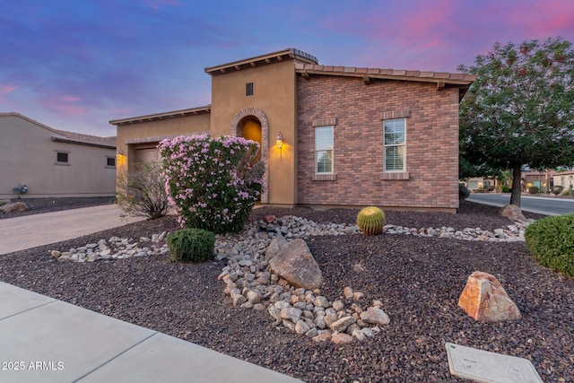 1260 E Sweet Citrus Dr, Queen Creek, AZ 85140 - view of front of property with a garage, brick siding, driveway, and stucco siding