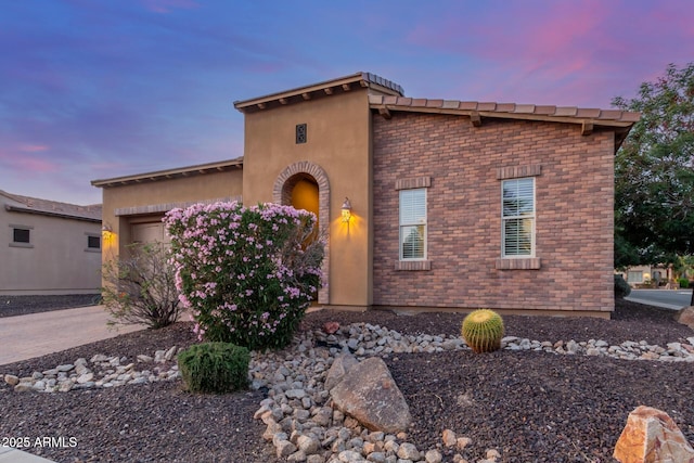 1260 E Sweet Citrus Dr, Queen Creek, AZ 85140 - view of front of property with a garage, brick siding, and driveway