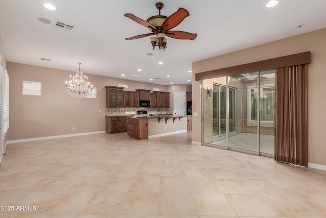 1260 E Sweet Citrus Dr, Queen Creek, AZ 85140 - kitchen featuring black microwave, open floor plan, a kitchen bar, a ceiling fan, and recessed lighting