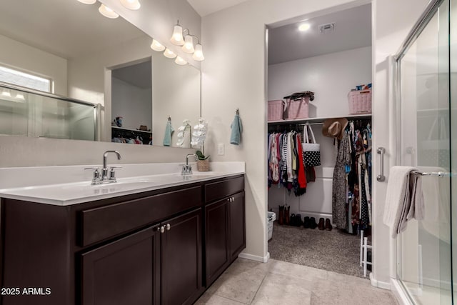 bathroom with vanity, tile patterned floors, and walk in shower