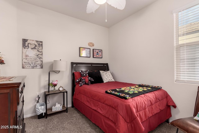 carpeted bedroom featuring multiple windows and ceiling fan