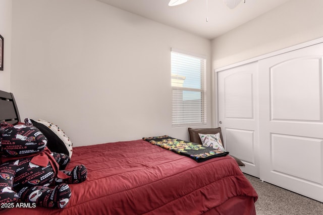 carpeted bedroom featuring ceiling fan and a closet