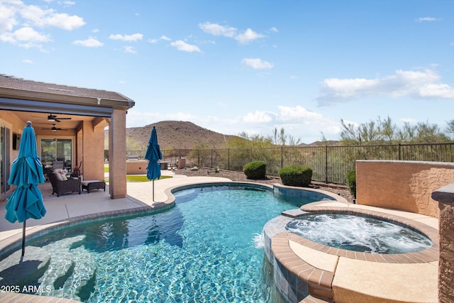 13072 W Alyssa Ln, Peoria, AZ 85383 - view of pool featuring a mountain view, a fenced backyard, ceiling fan, a patio area, and a pool with connected hot tub