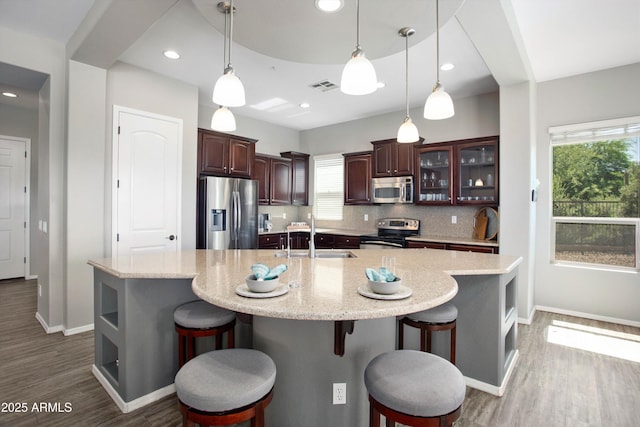 13072 W Alyssa Ln, Peoria, AZ 85383 - kitchen with stainless steel appliances, a sink, baseboards, backsplash, and wood finished floors