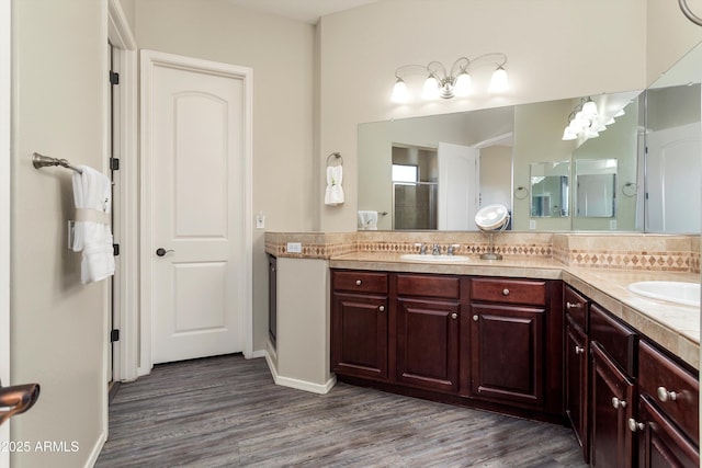 13072 W Alyssa Ln, Peoria, AZ 85383 - full bath featuring double vanity, wood finished floors, backsplash, and baseboards