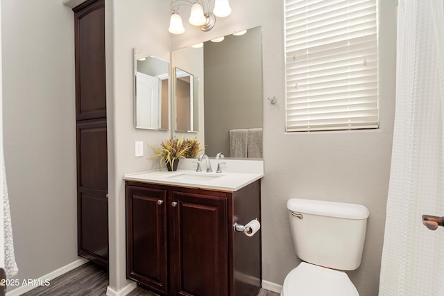 13072 W Alyssa Ln, Peoria, AZ 85383 - bathroom featuring vanity, toilet, wood finished floors, and baseboards