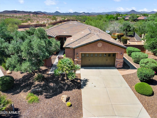 13072 W Alyssa Ln, Peoria, AZ 85383 - view of front facade featuring an attached garage, stucco siding, driveway, and stone siding