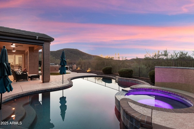 13072 W Alyssa Ln, Peoria, AZ 85383 - view of pool with a mountain view, a fenced backyard, a patio, a pool with connected hot tub, and a ceiling fan
