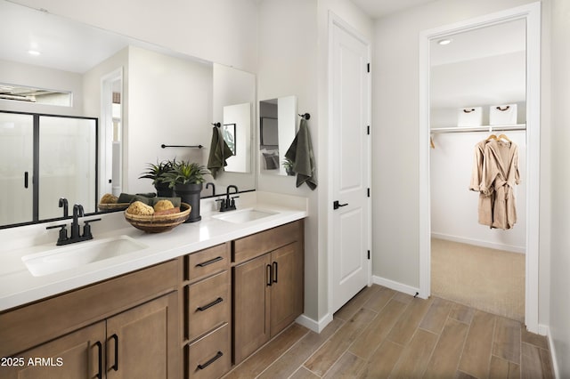 bathroom with vanity and a shower with shower door