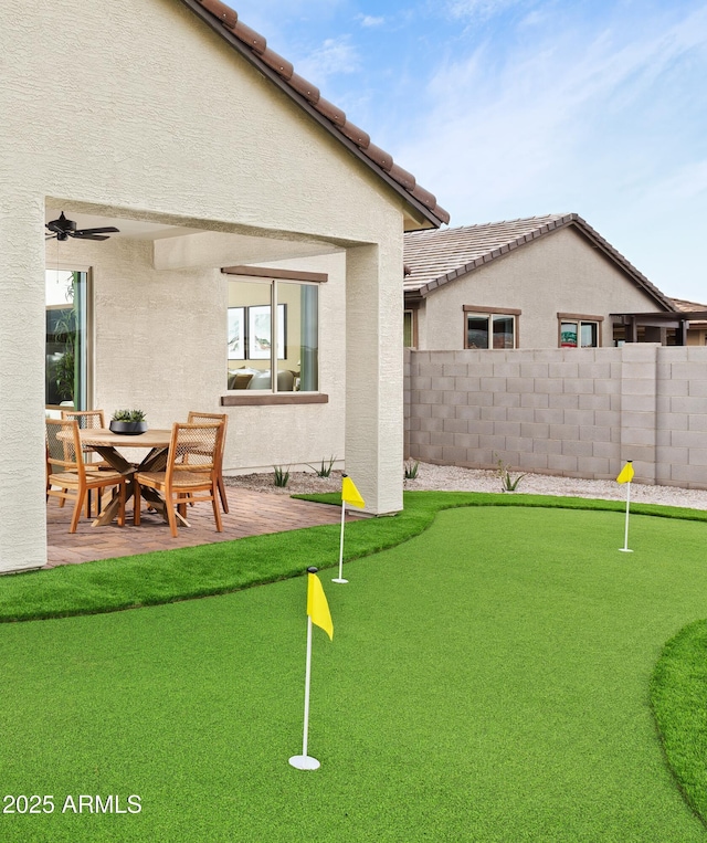 view of yard with a patio and ceiling fan