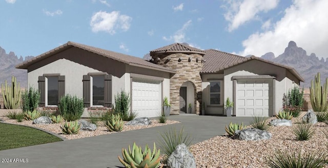 mediterranean / spanish house featuring a mountain view and a garage