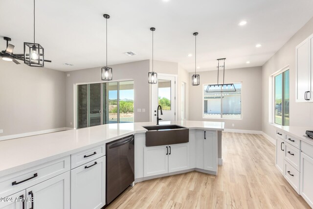 kitchen with hanging light fixtures, black dishwasher, and white cabinets