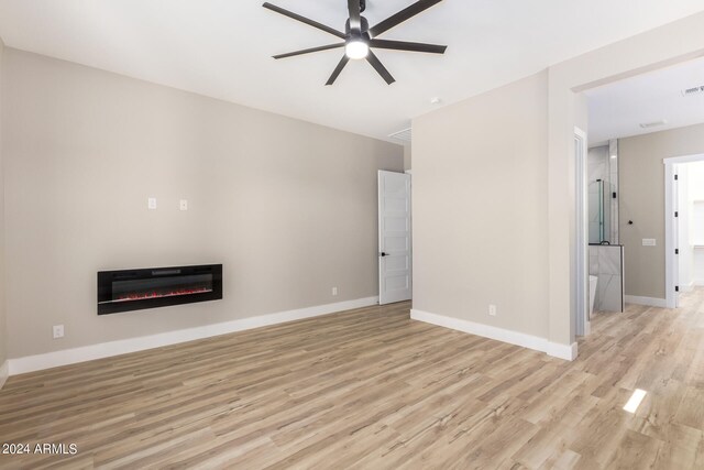 unfurnished living room featuring light wood-type flooring and ceiling fan