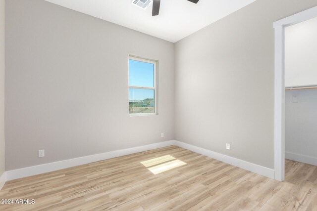 interior space with ceiling fan, a closet, and light hardwood / wood-style floors