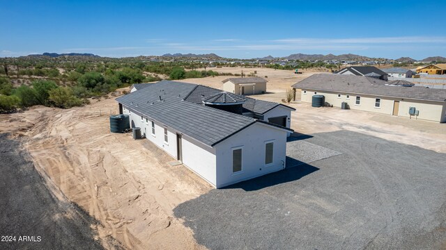 exterior space with a mountain view, a patio area, and central AC