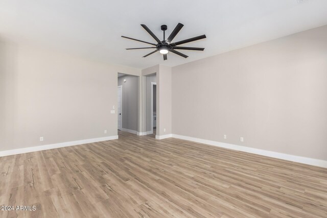 empty room featuring ceiling fan and light hardwood / wood-style flooring