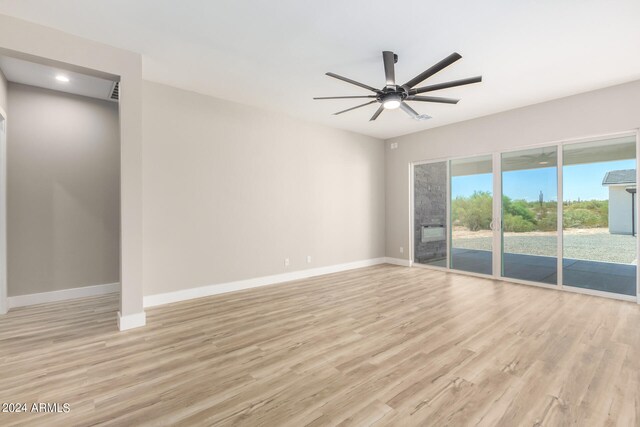 empty room with light hardwood / wood-style floors and ceiling fan