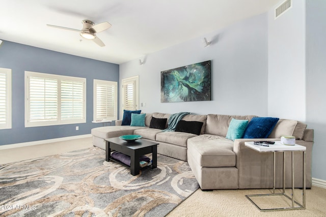 carpeted living room with ceiling fan