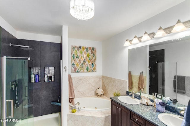 bathroom featuring vanity and shower with separate bathtub