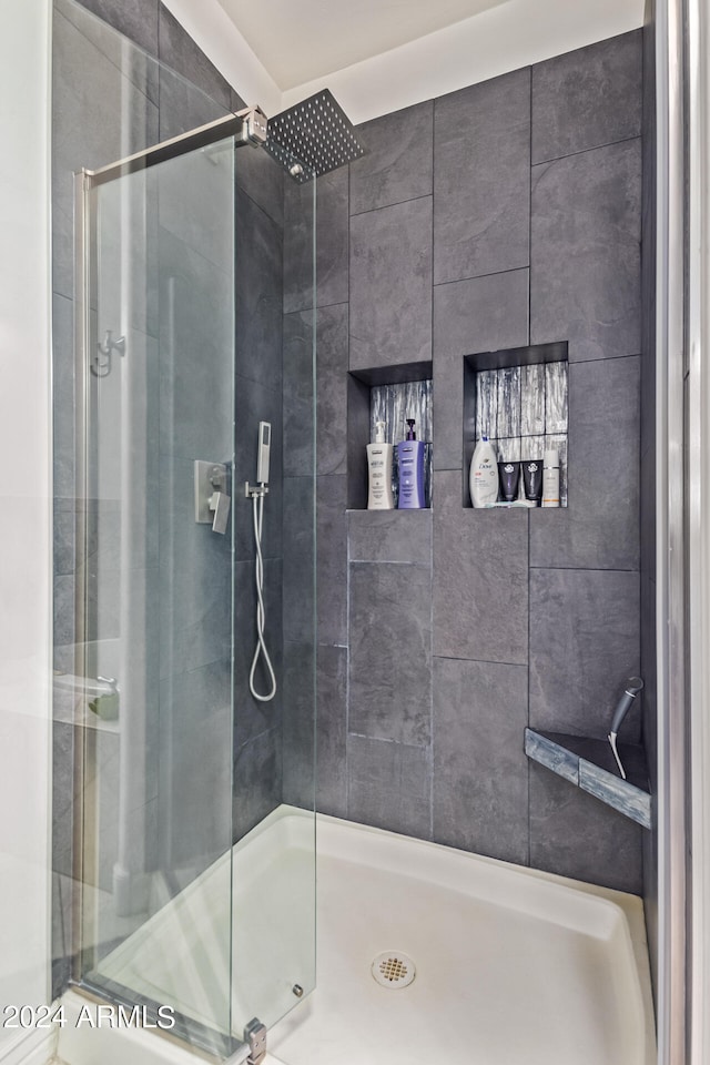 bathroom with a tile shower