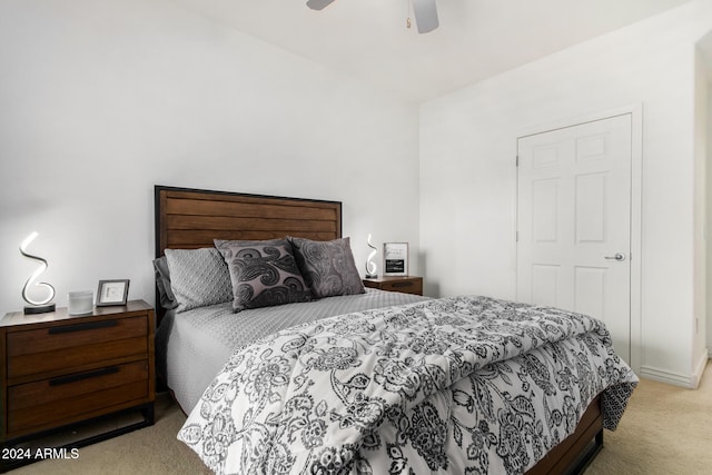 bedroom featuring light carpet and ceiling fan