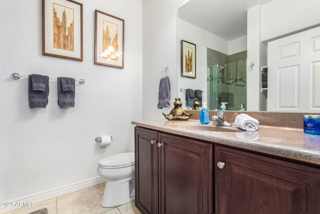 bathroom with an enclosed shower, vanity, tile patterned floors, and toilet