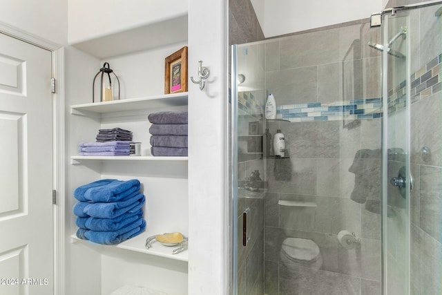 bathroom featuring a shower with door