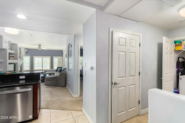 kitchen featuring light carpet, stainless steel dishwasher, and ceiling fan