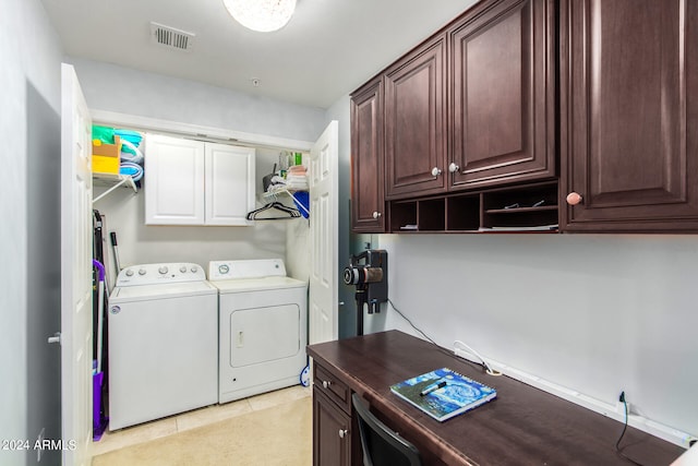 clothes washing area with cabinets, light tile patterned floors, and independent washer and dryer