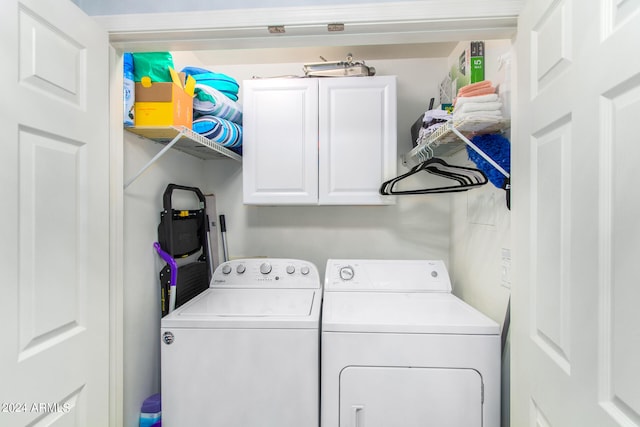 laundry room featuring cabinets and washing machine and dryer