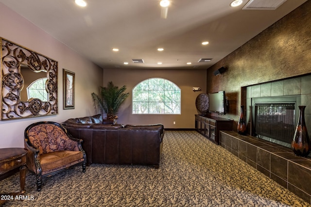 carpeted living room with a tiled fireplace