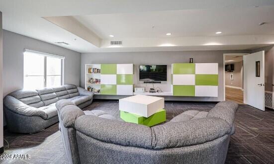 living room featuring a raised ceiling