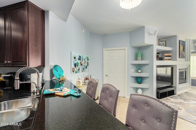 dining space featuring built in shelves and sink