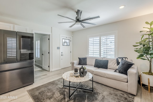 living room with light wood-style floors, recessed lighting, baseboards, and a ceiling fan