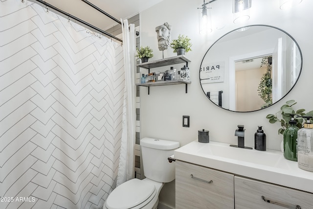 bathroom featuring curtained shower, vanity, and toilet