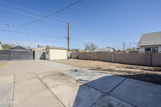 view of patio featuring a fenced backyard, a shed, and an outdoor structure