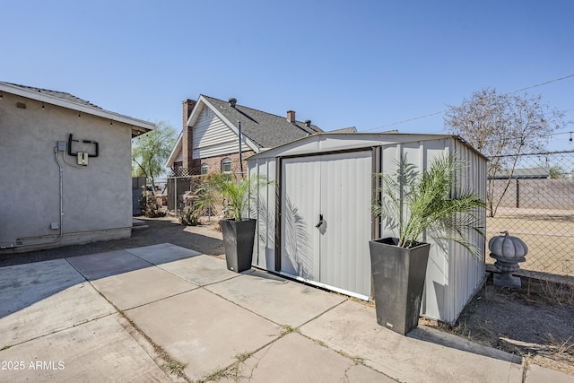 view of shed with fence