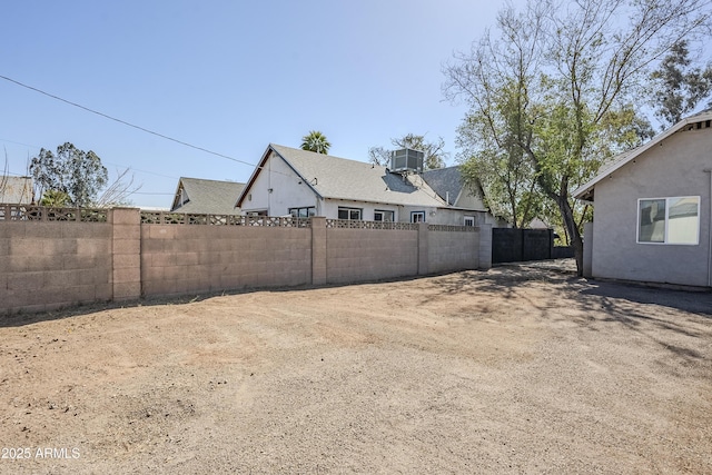 view of yard with fence and cooling unit