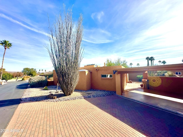 view of side of home with a patio