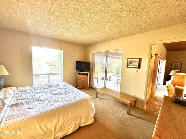 carpeted bedroom with a textured ceiling and access to outside