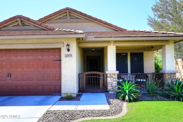 2005 E Anderson Dr E, Phoenix, AZ 85022 - view of front facade featuring a porch, an attached garage, stucco siding, and a tile roof