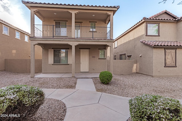 mediterranean / spanish-style house featuring a balcony and a patio