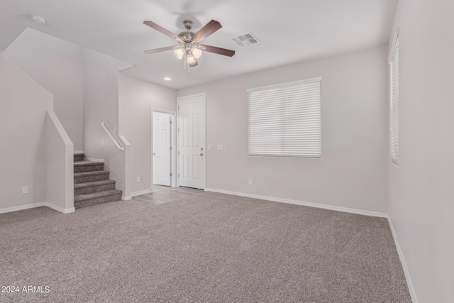 empty room with light carpet and ceiling fan